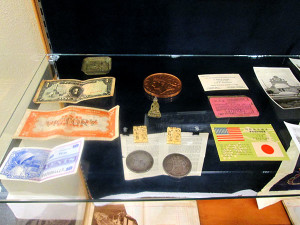 Samples of currency and souvenirs from sightseeing junkets. On the left are examples of "Victory Pesos" in Japan and the Phillipines; these were temporary forms of currency issued by the U.S. government.
